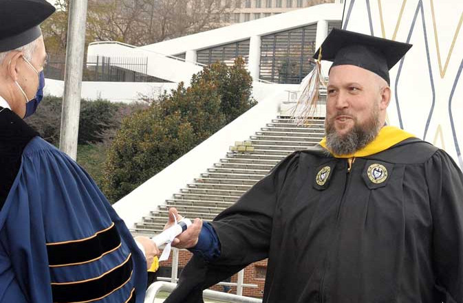 Rick Pangburn accepting his degree